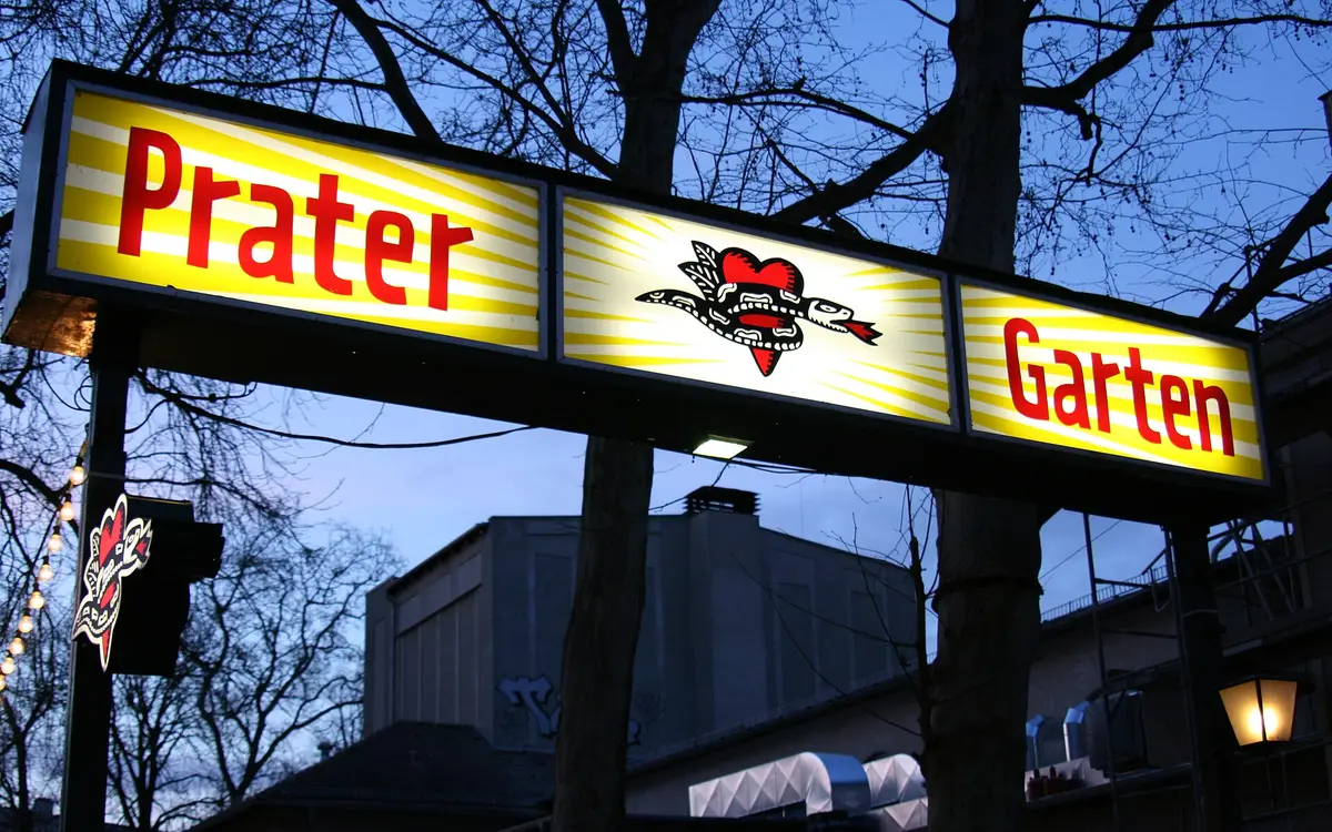 Illuminated Prater Garten sign at dusk on Kastanienallee in Berlin