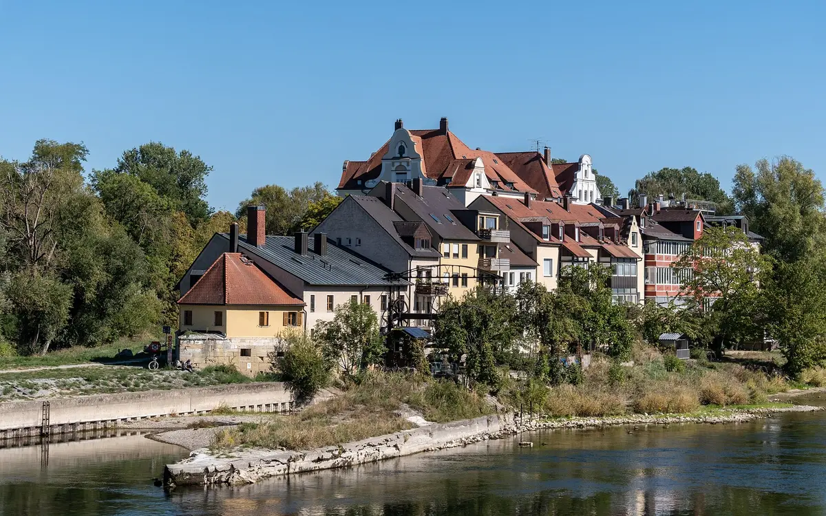A historic old-town street in Regensburg lined with medieval houses