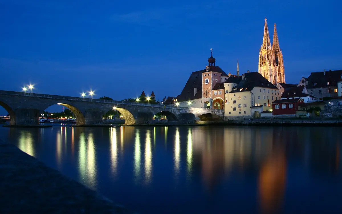 Regensburg at night with the cathedral and the Stone Bridge lit up
